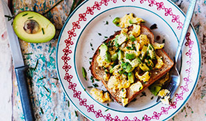 Scrambled eggs and avocado served with seeded toast