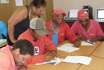 A group of people at a table in a training centre