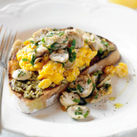 Scrambled eggs with mushrooms on truffle-pesto sourdough toast 
