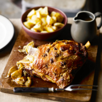 Slow-roast shoulder of lamb with anchovy, oregano & garlic with roast potatoes