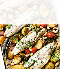 Baked sea bass with new potatoes, tomatoes  & roasted cashews