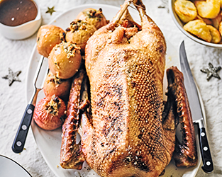 Slow-roast goose with honey & calvados-stuffed apples