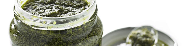 A jar of pesto with spoon