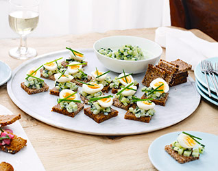 Quail's eggs and pickled cucumber on rye