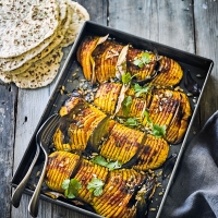 Hasselback spiced squash with coconut flatbreads & toasted seeds