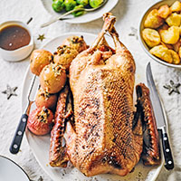 Slow-roast goose with honey & calvados-stuffed apples